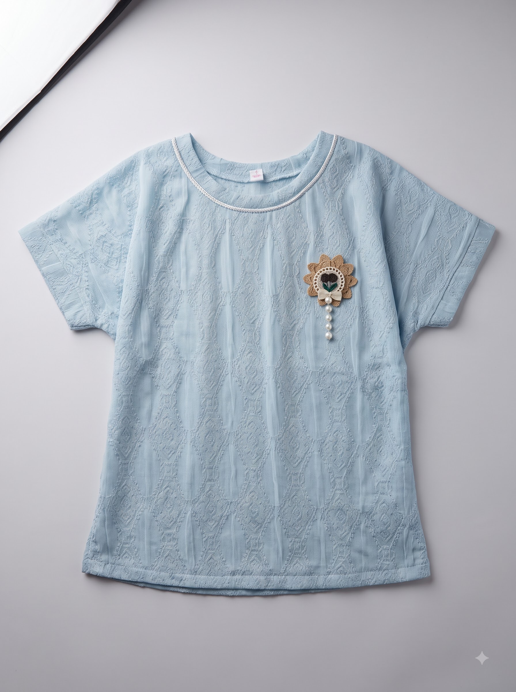 Girls Light Blue Textured Top with Floral Brooch and Pearl Detail - Image 2