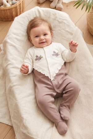 Shop this adorable baby girls' dusty pink dungaree set with white floral embroidery, ruffled straps, front pockets, scalloped trim, and a white ribbed T-shirt.